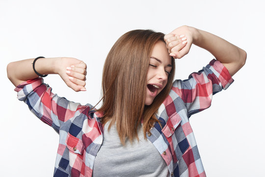 Portrait of a casual teen girl yawning