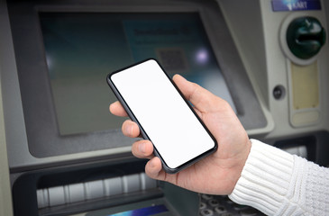 male hand holds phone with isolated screen at ATM