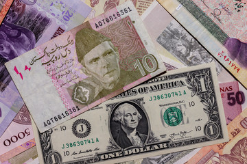 Fototapeta na wymiar Moscow, Russia - April 20, 2020: One US Dollar with Different Pakistani Rupee Banknotes