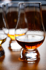 Flight of Scottish whisky, tasting glasses with variety of single malts or blended whiskey spirits on distillery tour in Scotland