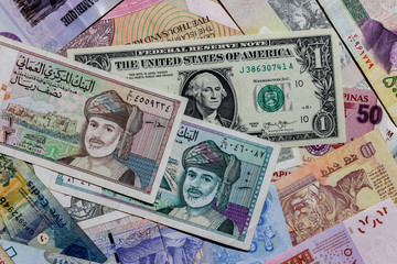 Fototapeta na wymiar Moscow, Russia - April 20, 2020: One US Dollar with Different Omani rial Banknotes