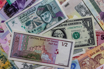 Fototapeta na wymiar Moscow, Russia - April 20, 2020: One US Dollar with Different Omani rial Banknotes