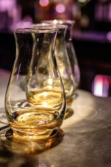 Flight of Scottish whisky, tasting glasses with variety of single malts or blended whiskey spirits on distillery tour in pub in Scotland