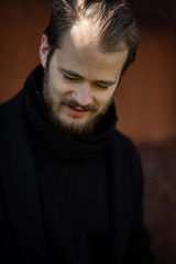 Handsome man wearing a mask on the streets of the city. Closeup of a young man in a respirator to protect against infection with influenza virus or coronavirus