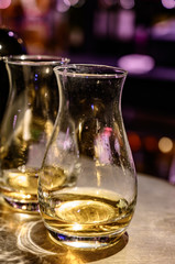 Flight of Scottish whisky, tasting glasses with variety of single malts or blended whiskey spirits on distillery tour in pub in Scotland
