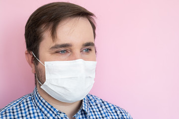 Man wearing protective mask on pink background, copyspace, copyplace, space for text. Coronavirus, illness, infection, quarantine, medical mask