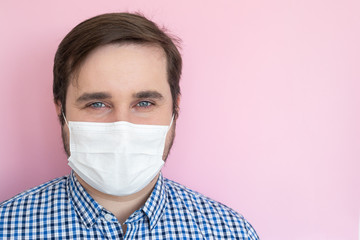 Man in protective face mask isolated on pink background, copyspace, copyplace, space for text. Coronavirus, illness, infection, quarantine, medical mask