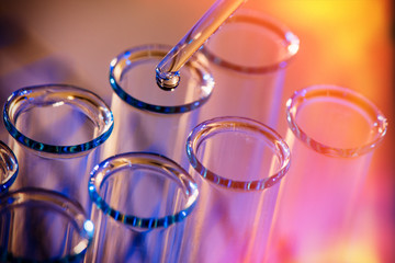 Test tube row. Concept of medical or science laboratory, liquid drop droplet with dropper in blue...