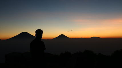silhouette of a man in the sunset at mount andong