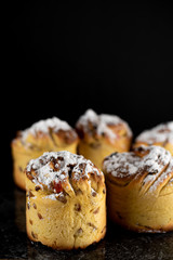 cruffins, The modern baking trend of the year is puffmuffin, a mix of croissants and cupcakes. On a black background sprinkled with powdered sugar