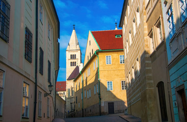 Empty narrow street in Prague castle. Tower of St. George's Basilica on background, Prague, Czech Republic