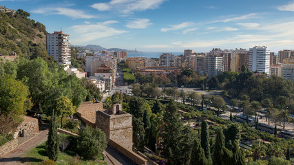 Malaga Spain panorama landscape cityscape and view of the coast, the sea, the bullring arena and the town skyline on a sunny day with clouds in the sky from the Alcazaba Fortress.