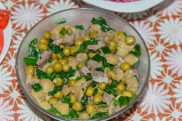 homemade salad of herring, mushrooms, green peas and leeks   