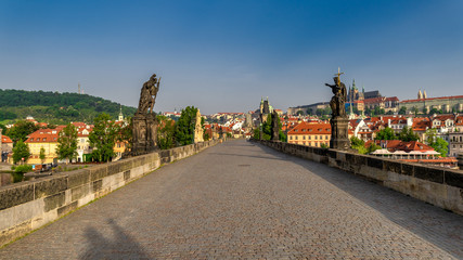 Fototapeta na wymiar Morning view of Charles Bridge in Prague, Czech Republic. The Charles Bridge is one of the most visited sights in Prague.
