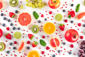 Fresh summer fruit, a flat lay on a white background, vibrant food pattern, overhead shot