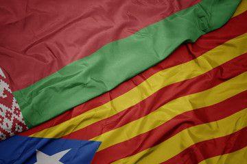 waving colorful flag of catalonia and national flag of belarus.