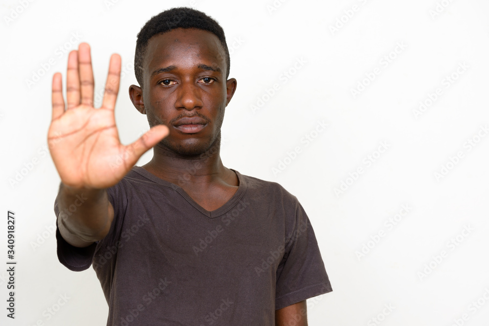 Wall mural portrait of young african man with stop sign