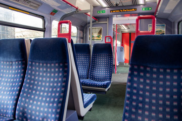 empty seats on the inside of a British train carriage