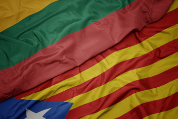 waving colorful flag of catalonia and national flag of lithuania.