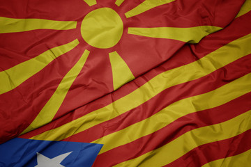 waving colorful flag of catalonia and national flag of macedonia.