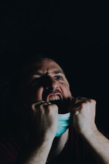 Coronavirus, covid 19. A man fighting under a mask.