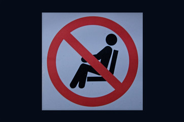 Prohibit no sitting sign on black background