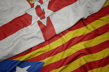 waving colorful flag of catalonia and national flag of northern ireland.
