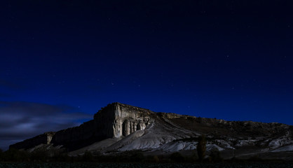 Fototapeta na wymiar White rock at night, moonlight, Crimean starry sky