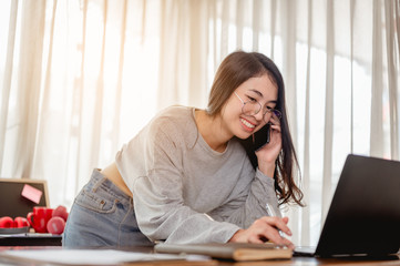 Woman work from home have a coffee cup beside wait epidemic situation to improve soon at home. Coronavirus, covid-19, Work from home (WFH), Social distancing, Quarantine, Prevent infection concept.