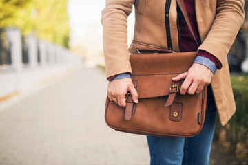 Close up of a businessman holding a briefcase.