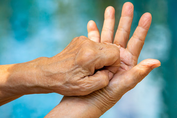Fototapeta premium Senior woman's hands washing her hands in step 6 on bokeh blue pool background, Close up & Macro shot, Selective focus, Prevention from covid19, Bacteria, healthcare concept, 7 step wash hand