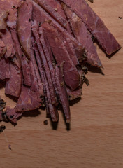 Black peppercorn roast beef. Close-up macro photo of julian chopped roast beef on yellow coffee...