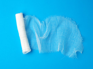 roll of white gauze bandage on a blue background