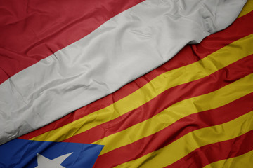 waving colorful flag of catalonia and national flag of indonesia.