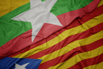 waving colorful flag of catalonia and national flag of myanmar.