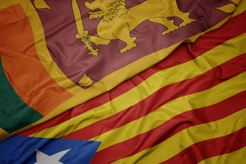waving colorful flag of catalonia and national flag of sri lanka.