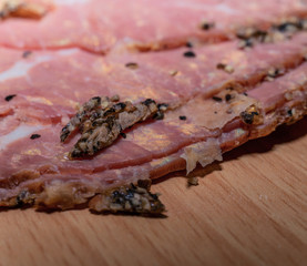 Black peppercorn roast beef. Close-up macro photo of julian chopped roast beef on yellow coffee...