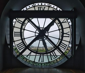 Big window clock at the Orsay Museum (Musee d Orsay) with Tuileries Garden and big wheel view.