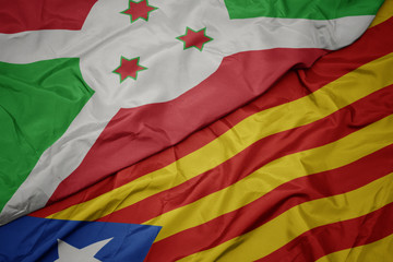 Fototapeta premium waving colorful flag of catalonia and national flag of burundi .