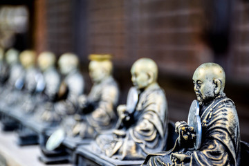 Small holy bronze statuettes in a shrine somewhere in Hiroshima prefecture, Japan