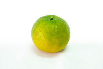 Fresh green tangerine on white background. selective focus, soft focus.