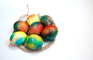7 multicolored Easter eggs together on a white background. A place for text. Easter greeting card