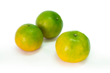Fresh green tangerine on white background. selective focus, soft focus.