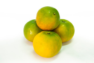 Fresh green tangerine on white background. selective focus, soft focus.