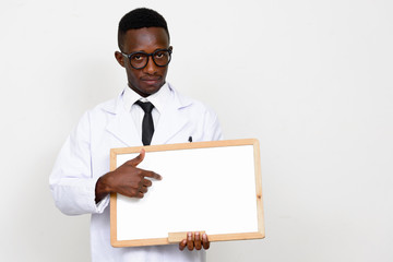 Portrait of young African man doctor showing white board
