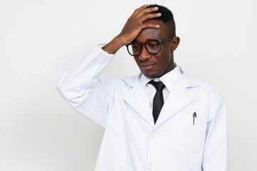 Portrait of stressed young African man doctor having headache