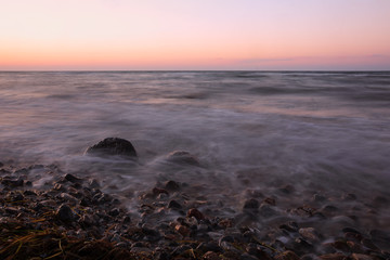 Obraz premium scenic sea coast at dawn with smooth water of the time exposure, romantic marine wallpaper