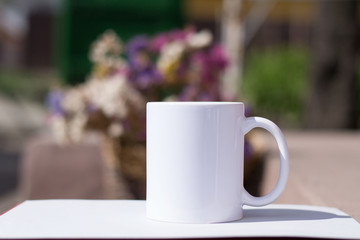 white cup for sublimation printing ouydoor on the colored background of flowers