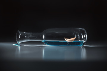 A paper boat inside a glass bottle