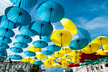Fototapeta na wymiar Multi-colored umbrellas on a background of blue sky